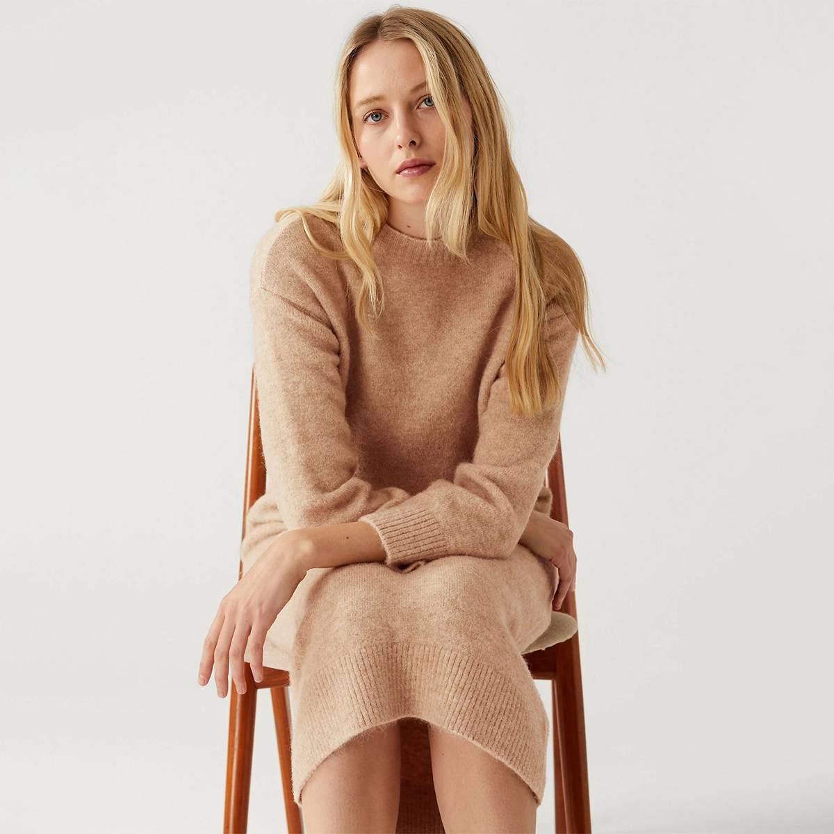  Model wearing tan knitted dress
